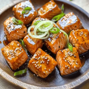 - 1 lb fresh salmon fillet, skinless and cubed - 1/4 cup soy sauce - 2 tablespoons honey - 1 tablespoon rice vinegar - 1 tablespoon sesame oil - 1 teaspoon grated ginger - 2 cloves garlic, minced Fresh salmon is the star of this dish. I always choose skinless fillets for easy cooking. The marinade is key to great taste. Soy sauce adds saltiness, while honey brings sweetness. Rice vinegar gives it a nice tang. Sesame oil adds a rich flavor. Ginger and garlic boost the taste with a warm kick. - 2 green onions, sliced - Sesame seeds, for garnish Green onions add crunch and freshness. I love using them as a topping. They brighten up the dish. Sesame seeds add a nice crunch and look great. You can toast them for extra flavor if you want. You can also use fresh herbs for garnish. Cilantro or parsley can add a pop of color. Lime or lemon wedges work well too. They add a zesty touch when squeezed over the salmon. Feel free to get creative with your garnishes! To make the marinade, grab a mixing bowl. In this bowl, combine: - 1/4 cup soy sauce - 2 tablespoons honey - 1 tablespoon rice vinegar - 1 tablespoon sesame oil - 1 teaspoon grated ginger - 2 cloves garlic, minced Whisk these ingredients together until they blend well. This mixture will give your salmon bites a savory and sweet taste. Now, take your 1 lb of fresh salmon fillet. Cut it into bite-sized cubes, about 1 inch each. Add these salmon pieces to the marinade. Toss well to coat each piece. Cover the bowl and place it in the fridge. Let the salmon sit for at least 30 minutes. If you have time, marinate for up to 2 hours. This step helps the flavors soak in deeply. Preheat your air fryer to 400&deg;F (200&deg;C). This usually takes about 5 minutes. After preheating, remove the salmon from the marinade. Let the excess marinade drip off. Arrange the salmon cubes in the air fryer basket. Be sure they don't touch each other. This helps them cook evenly. Cook for 8-10 minutes. Flip the salmon halfway through to get a nice golden color. Once done, take the salmon out and let it rest for a couple of minutes. Before serving, top with sliced green onions and sesame seeds for a nice touch. To get the best salmon bites, choose fresh salmon. Look for bright color and no strong smell. Cut the salmon into even cubes. This helps them cook at the same rate. For a tender bite, do not overcook. Salmon should be flaky but still moist. Marinating is key for flavor. I suggest at least 30 minutes in the fridge. For even richer taste, marinate up to 2 hours. This allows the soy sauce, honey, and ginger to soak in. Do not marinate too long; the fish can become mushy. Preheat your air fryer to 400&deg;F (200&deg;C). This helps the salmon cook evenly. Place the salmon cubes in a single layer. Avoid overcrowding the basket. Flip the pieces halfway through cooking for even browning. Rest the salmon for a few minutes before serving. This helps improve texture and flavor. {{image_2}} To add some heat, try spicy teriyaki salmon bites. Use the same recipe but add sriracha or red pepper flakes to the marinade. Start with one teaspoon of sriracha and adjust to your taste. This adds a nice kick without overpowering the dish. The sweet teriyaki flavor pairs well with the heat, making it a fun twist. You don&rsquo;t have to stick to the same marinade. Experiment with new flavors! Instead of soy sauce, try tamari for a gluten-free option. You can also use maple syrup instead of honey for a different sweetness. For a citrus twist, add orange juice or lime juice to the mix. Each change gives the salmon a unique flavor profile. These teriyaki salmon bites are great on their own, but you can elevate them! Serve with steamed rice or quinoa to soak up the delicious sauce. A side of stir-fried vegetables adds color and crunch. You can also make a fresh salad with mixed greens and a light vinaigrette. This keeps the meal healthy and vibrant. To store leftovers, place them in an airtight container. Make sure to let the salmon cool first. Keep it in the fridge for up to three days. If you want to keep it longer, freezing is a good option. When reheating, use the air fryer for the best results. Preheat the air fryer to 350&deg;F (175&deg;C). Place the salmon bites in the basket. Heat them for about 4-5 minutes. This keeps them crispy and tasty. You can also use the microwave, but it may make them a bit soggy. To freeze the salmon bites, place them in a freezer-safe bag. Remove as much air as possible before sealing. They can be frozen for up to three months. When ready to eat, thaw them in the fridge overnight. Then, follow the reheating tips to enjoy them again. Yes, you can use frozen salmon. However, it&rsquo;s best to thaw it first. Thawing helps the marinade soak in better. To thaw salmon, place it in the fridge overnight or put it in a sealed bag under cold water for about an hour. Once thawed, follow the same steps for marinating and cooking. The best air fryer temperature for salmon is 400&deg;F (200&deg;C). This high heat cooks the salmon quickly. It helps create a nice, crispy outside while keeping the inside moist. Preheating your air fryer for about 5 minutes at this temperature is key. Cook salmon bites in the air fryer for 8-10 minutes. Flip them halfway through to ensure even cooking. The salmon should be opaque and flaky when done. If you prefer it more golden, you can cook it for an extra minute or two. This blog covered how to make great salmon in an air fryer. We went through marinade basics, cooking steps, and tips for perfect salmon. You now have ways to mix flavors and serve your dish. Don&rsquo;t forget how to store any leftovers too. Enjoy easy cooking while trying new recipes. I hope you feel ready to make delicious air fryer salmon tonight!