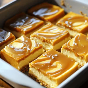 To make these delicious bars, you need a few key ingredients: - 1 cup graham cracker crumbs - 1/4 cup unsalted butter, melted - 2 tablespoons brown sugar - 2 cups cream cheese, softened - 1 cup pumpkin puree - 1/2 cup powdered sugar - 1 teaspoon vanilla extract - 1 teaspoon pumpkin pie spice - 1/2 cup heavy whipping cream - 1/2 cup caramel sauce, plus extra for topping - A pinch of sea salt Each ingredient plays an important role. The graham cracker crumbs form a sweet crust. The cream cheese and pumpkin give the filling a rich and creamy texture. The caramel sauce adds a sweet touch on top. If you need to make changes, here are some easy swaps: - Use crushed digestive biscuits instead of graham crackers for a different crust flavor. - Replace the unsalted butter with coconut oil for a dairy-free option. - Try Greek yogurt instead of cream cheese for a lighter filling. - Maple syrup can replace powdered sugar if you want natural sweetness. - You can use almond milk or oat cream instead of heavy cream for a dairy-free version. These substitutions can help you customize the recipe to your taste. To ensure the best taste, use fresh and high-quality ingredients: - Choose real pumpkin puree, not pumpkin pie filling. It should be pure and smooth. - Look for full-fat cream cheese. This gives a creamy and rich filling. - Use fresh spices. They add a stronger flavor to your bars. - Opt for high-quality caramel sauce. A good sauce enhances the overall taste. Quality ingredients make a big difference here. They help create a treat that everyone will enjoy. To start, gather your ingredients for the crust. You need: - 1 cup graham cracker crumbs - 1/4 cup unsalted butter, melted - 2 tablespoons brown sugar In a bowl, mix the graham cracker crumbs, melted butter, and brown sugar. Stir until it looks like wet sand. This mixture forms a tasty base for your cheesecake. Next, press it firmly into a greased 9x9-inch baking dish. Make sure to spread it evenly. Once done, place the dish in the refrigerator. Let it chill while you make the filling. Now it&rsquo;s time for the filling. You will need: - 2 cups cream cheese, softened - 1 cup pumpkin puree - 1/2 cup powdered sugar - 1 teaspoon vanilla extract - 1 teaspoon pumpkin pie spice - 1/2 cup heavy whipping cream - 1/2 cup caramel sauce, plus extra for topping - A pinch of sea salt In a large bowl, beat the softened cream cheese until it&rsquo;s smooth. This step ensures a creamy texture. Then, add the pumpkin puree, powdered sugar, vanilla extract, and pumpkin pie spice. Mix until everything is well combined. In another bowl, whip the heavy cream until stiff peaks form. This makes the filling light and fluffy. Gently fold the whipped cream into the pumpkin mixture. Be careful not to deflate it. Pour the pumpkin cheesecake filling over the chilled crust. Spread it evenly to the edges. Now, for a fun touch, drizzle caramel sauce on top in a swirling pattern. Use a knife to create swirls or marbling. This adds both flavor and a beautiful look. Sprinkle a pinch of sea salt on top for contrast. Cover the dish with plastic wrap and place it in the refrigerator. Chill for at least 4 hours, or until it sets nicely. Once set, cut the bars into squares. Drizzle more caramel sauce over each piece before serving. Enjoy your delicious, no-bake treat! To get the best texture for your cheesecake bars, focus on the cream cheese. Make sure it is soft. This helps it blend smoothly. Beat it well before adding other ingredients. When mixing in the pumpkin puree, ensure there are no lumps. Whipping the heavy cream is key. Beat it until stiff peaks form, then fold it gently into the pumpkin mixture. This step adds air, making the bars light and fluffy. You want them creamy but not too dense. One common mistake is not chilling the bars long enough. You must refrigerate them for at least four hours. If you cut them too soon, they will fall apart. Another mistake is skipping the sea salt. A pinch of salt brings out the flavors. Without it, the bars may taste flat. Lastly, avoid over-mixing your filling after adding the whipped cream. This can deflate the mixture and change the texture. To add more flavor, try using fresh spices. Instead of just pumpkin pie spice, add a bit of cinnamon or nutmeg. This can give the bars a warm, cozy taste. You can also mix in chopped nuts or chocolate chips for a fun twist. Drizzling extra caramel on top adds sweetness and richness. If you want a more decadent flavor, consider using cream cheese with a hint of vanilla. This small change can elevate the whole dessert. {{image_2}} You can play with flavors in your cheesecake bars. Think about chocolate, berry, or mint. For a chocolate version, mix in cocoa powder with the cream cheese. For berry flavors, swirl in pureed raspberries or strawberries. You can also try adding a hint of coffee for a mocha twist. Each flavor adds a fun spin to your bars. Want to make your bars a bit healthier? Try using Greek yogurt instead of cream cheese. It adds protein and keeps the texture creamy. You can swap out the brown sugar for honey or maple syrup. This change lowers refined sugar while adding unique flavors. For a gluten-free option, use almond flour instead of graham cracker crumbs. These swaps keep your dessert tasty and lighter. You can change the bars for each season. In fall, add apple pie spice for an autumn vibe. For winter, mix in peppermint extract for a festive flavor. In spring, try adding lemon zest for a fresh taste. Each season offers new ideas to keep your dessert exciting. Don't forget to top with seasonal fruits for a colorful touch! Storing your no bake caramel pumpkin cheesecake bars is easy. Keep them in the fridge. Use an airtight container to keep them fresh. You can also cover the dish tightly with plastic wrap. Make sure the bars are fully chilled before storing. This helps maintain their creamy texture. You can freeze these cheesecake bars for later. First, cut them into squares. Wrap each square in plastic wrap. Then, place them in a freezer-safe bag. Press out as much air as you can. They will stay fresh for up to three months. When you're ready to eat them, thaw them in the fridge overnight. These cheesecake bars taste best within a week. They will stay good for up to five days in the fridge. After that, the texture may change. If you freeze them, they remain good for three months. Always check for any signs of spoilage before serving. Enjoy your tasty treat! Yes, you can use homemade caramel sauce. Making it at home can add a personal touch. Just ensure it&rsquo;s thick enough to drizzle. Homemade sauce often tastes fresher and richer. You can adjust the sweetness to your liking too. If you don&rsquo;t have heavy cream, try using whipped coconut cream. It gives a similar texture and taste. You can also use half-and-half or evaporated milk. These options may change the taste slightly, but the bars will still be delicious. Chill the bars for at least four hours. This helps them set properly. If you have time, chilling them overnight is even better. The flavors meld together as they chill, making each bite even more delightful. You learned how to make no-bake caramel pumpkin cheesecake bars with easy steps. I shared tips on choosing the best ingredients, along with fun variations. Storing and freezing information helps keep your dessert fresh. Remember to avoid common mistakes for perfect results. These bars are not just tasty; they are fun to make for any occasion. Enjoy experimenting with flavors and enjoy your sweet treat!