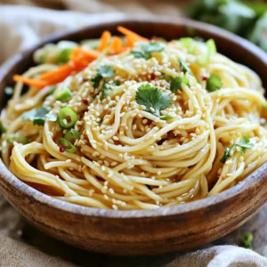 To make Minute Sesame Garlic Noodles, you need: - 8 oz spaghetti or rice noodles - 3 tablespoons sesame oil - 4 cloves garlic, minced - 2 tablespoons soy sauce - 1 tablespoon honey or maple syrup - 1 tablespoon rice vinegar - 1 tablespoon toasted sesame seeds - 2 green onions, finely chopped - 1 small carrot, julienned (for garnish) - Fresh cilantro leaves for garnish (optional) - Red pepper flakes (optional, for heat) If you don't have some of these items, here are some easy swaps: - Use whole wheat noodles instead of spaghetti or rice noodles. - Swap sesame oil for olive oil if needed. - Replace honey with agave syrup or brown sugar. - Use apple cider vinegar instead of rice vinegar. - Green onions can be replaced with chives or shallots. To ensure your dish tastes great, focus on ingredient quality: - Choose fresh garlic for the best flavor. - Use high-quality soy sauce for a deeper taste. - Look for vibrant green onions. They add color and crunch. - For the best sesame seeds, toast them lightly for more flavor. - Fresh herbs like cilantro brighten the dish. Use them if you can. First, grab a large pot. Fill it with water and add a pinch of salt. Bring the water to a boil. Add 8 ounces of spaghetti or rice noodles. Cook them for about 4 to 6 minutes or until they feel firm yet soft, called al dente. Once done, drain the noodles and set them aside. Now, let&rsquo;s make the sauce. In a small bowl, combine 3 tablespoons of sesame oil, 4 minced garlic cloves, 2 tablespoons of soy sauce, 1 tablespoon of honey or maple syrup, and 1 tablespoon of rice vinegar. Whisk these ingredients together until they blend well. The sauce should smell amazing and look smooth. In a large mixing bowl, toss the drained noodles with the sauce. Make sure every noodle gets coated. Next, sprinkle 1 tablespoon of toasted sesame seeds and 2 finely chopped green onions over the noodles. If you like some heat, add red pepper flakes to taste. Gently toss everything again to mix. Finally, serve the noodles in bowls. Top them with julienned carrots and fresh cilantro for a colorful touch. Enjoy your delicious meal! To make the best sauce, use fresh garlic. Fresh garlic gives a strong taste. Mince the garlic finely for even flavor. Combine sesame oil, soy sauce, honey, and rice vinegar in a bowl. Whisk until smooth. This mix should taste sweet and salty. If you want, add a bit more honey for sweetness. Adjust the soy sauce for saltiness. This sauce is key for great noodles. For perfect noodles, boil salted water first. Add the spaghetti or rice noodles. Cook until al dente, usually 4 to 6 minutes. Stir the noodles gently to prevent sticking. Drain them well, but don&rsquo;t rinse. Rinsing washes away the starch that helps the sauce stick. Keep the noodles warm until you mix them with the sauce. To add more flavor, think about toppings. Toasted sesame seeds give a nutty taste. Chopped green onions add freshness. If you like heat, sprinkle red pepper flakes on top. You can also add julienned carrots for crunch. Fresh cilantro can brighten the dish. These extras make the meal more colorful and tasty. {{image_2}} You can make your Minute Sesame Garlic Noodles even better by adding veggies. Some great choices are: - Bell peppers: Slice them thin for a sweet crunch. - Broccoli: Steam small florets to add texture. - Snap peas: Toss them in for a fresh, crisp taste. - Spinach: Stir in fresh leaves for extra color and nutrients. Feel free to mix and match any of these vegetables. They all pair well with the noodles and sauce. Adding protein makes this meal even more filling. Here are some tasty ideas: - Chicken: Grilled or shredded chicken gives a savory flavor. - Tofu: Use firm tofu for a plant-based option; pan-fry until golden. - Shrimp: Quick-cook shrimp for a nice seafood twist. - Eggs: Scramble a couple of eggs and mix them in for added richness. These proteins can boost the meal's health and taste. If you need a gluten-free option, simply swap out the noodles. Here are some great choices: - Rice noodles: They work perfectly as a substitute in this recipe. - Zucchini noodles: Spiralized zucchini adds a fresh twist and keeps it light. - Quinoa: This grain is gluten-free and offers a nutty flavor. With these options, anyone can enjoy this dish, no matter their dietary needs. Store your leftover Minute Sesame Garlic Noodles in an airtight container. This keeps them fresh and tasty. You can keep them in the fridge for up to three days. Make sure they are cooled down before you store them to avoid moisture buildup. If you need to stack them, place parchment paper between layers to prevent sticking. To reheat the noodles, you can use a microwave or a stove. For the microwave, place the noodles in a bowl. Add a splash of water to keep them moist. Heat for about 1-2 minutes, stirring halfway. If you prefer the stove, put the noodles in a pan over low heat. Add a little sesame oil to help them heat evenly. Stir until they are warmed throughout. If you want to save the noodles for longer, freezing is an option. First, let the noodles cool completely. Then, place them in a freezer-safe bag. Remove as much air as you can before sealing. They can stay in the freezer for about one month. When you are ready to eat them, thaw the noodles in the fridge overnight before reheating. Minute Sesame Garlic Noodles can last for about 3 to 5 days in the fridge. Store them in an airtight container to keep them fresh. Make sure they cool down before sealing the container. If you see any signs of spoilage, throw them away to stay safe. Yes, you can use different noodles! Rice noodles work well if you want a gluten-free option. You can also try whole wheat or egg noodles for different textures. Just make sure to adjust the cooking time based on the type of noodle you choose. To make the dish spicier, add red pepper flakes to the noodles. Start with a pinch and adjust to your taste. You can also include sliced fresh chili peppers or a dash of hot sauce. These options will give your noodles a nice kick! In this post, we covered everything you need for perfect Minute Sesame Garlic Noodles. We discussed key ingredients, tasty variations, and practical cooking tips. Remember, fresh ingredients make a big difference. You can always mix in veggies and proteins for more flavor and nutrition. Proper storage keeps leftovers tasty, and don&rsquo;t forget to experiment with heat levels. Enjoy cooking and sharing this dish! Your kitchen will fill with amazing smells, and your meal will impress everyone.