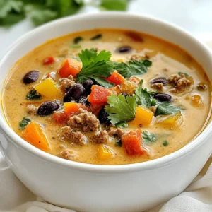 To make Creamy Cowboy Soup, you need a mix of hearty ingredients. Each one adds flavor and texture to the dish. Here&rsquo;s the full list of what you'll need: - 1 pound ground beef - 1 medium onion, diced - 2 cloves garlic, minced - 2 medium carrots, diced - 1 medium red bell pepper, diced - 1 can (15 oz) black beans, drained and rinsed - 1 can (15 oz) corn, drained - 1 can (14.5 oz) diced tomatoes with green chilies - 4 cups beef broth - 1 cup heavy cream - 2 teaspoons chili powder - 1 teaspoon cumin - 1 teaspoon smoked paprika - Salt and pepper to taste - 2 tablespoons olive oil - Fresh cilantro or parsley for garnish Each ingredient plays a key role. The ground beef gives the soup its rich base. Onions and garlic add depth and aroma. Carrots and bell peppers bring a sweet crunch. Black beans and corn add heartiness. Diced tomatoes offer a tangy kick. Beef broth gives the soup its savory profile. Heavy cream makes it creamy and smooth. Spices like chili powder, cumin, and smoked paprika add warmth and a hint of smoke. Don&rsquo;t forget to add salt and pepper to enhance all the flavors. Use fresh cilantro or parsley as a garnish for a pop of color and freshness. With these ingredients, you will create a soup that is both hearty and full of flavor. {{ingredient_image_1}} 1. Saut&eacute;ing onions and garlic: Start by heating 2 tablespoons of olive oil in a large pot over medium heat. Add the diced onion and saut&eacute; for about 4-5 minutes. You want the onion to be soft and slightly translucent. Then, add 2 cloves of minced garlic and cook for another minute until you can smell the garlic. 2. Cooking the ground beef: Next, add 1 pound of ground beef to the pot. Use a spoon to break it up as it cooks. Cook it for about 6-7 minutes, until it turns brown. If there is too much fat, drain it out. 3. Adding vegetables and ingredients: Now, stir in 2 diced carrots and 1 diced red bell pepper. Cook these for about 5 minutes until they start to soften. After that, add 1 can of black beans (drained and rinsed), 1 can of corn (drained), 1 can of diced tomatoes with green chilies, and 4 cups of beef broth. Mix in 2 teaspoons of chili powder, 1 teaspoon of cumin, 1 teaspoon of smoked paprika, along with salt and pepper to taste. 1. Bringing the soup to a boil: Increase the heat to high and bring the soup to a boil. This step helps blend all the flavors together. 2. Simmering the ingredients: Once the soup boils, reduce the heat to low. Allow it to simmer for 15-20 minutes. This helps the flavors meld nicely. 3. Finishing touches with heavy cream: Stir in 1 cup of heavy cream and cook for another 5 minutes. This adds a rich, creamy texture to the soup. Taste it, and adjust the seasoning with salt and pepper if needed. To boost the taste of your Creamy Cowboy Soup, adjust your spices. Start by adding more chili powder for heat. If you like smoky flavors, increase the smoked paprika. Don't forget salt and pepper; they can make a big difference. Recommended spices include: - Chili powder - Cumin - Smoked paprika These spices work well together, giving the soup a rich and bold flavor. Mix them in as you cook for the best results. For the best texture, cook the beef until it&rsquo;s nicely browned. This adds depth to the soup. When you add the carrots and bell peppers, cook them until soft but still crunchy. This keeps the vegetables from becoming mushy. Cooking times for perfect vegetables: - Saut&eacute; onions and garlic for 5 minutes. - Cook carrots and red bell pepper for 5 minutes. These times help keep your veggies flavorful and vibrant. Presentation matters! For a lovely finish, garnish your soup with fresh cilantro or parsley. This adds a pop of color and freshness. Pairing ideas for meals: - Serve with crusty bread for dipping. - Pair with a light salad for balance. These options make your meal more satisfying and enjoyable. Pro Tips Use Lean Ground Beef: Opt for lean ground beef (90% lean or higher) to reduce excess fat and calories in your soup. Add Extra Veggies: Feel free to toss in additional vegetables like zucchini or spinach for added nutrition and flavor. Adjust Thickness: If you prefer a thicker soup, let it simmer longer or add a cornstarch slurry to achieve your desired consistency. Garnish Variations: Experiment with different garnishes like avocado slices or shredded cheese for extra creaminess and flavor. {{image_2}} You can switch up the proteins in this soup. Ground beef works great, but you can try chicken or turkey. These meats cook fast, making them easy to use. For a veggie option, use lentils or chickpeas. They add protein and fiber without the meat. Feel free to add or swap out vegetables too. You can try zucchini, spinach, or even sweet potatoes. These choices give the soup more color and taste. Each swap makes the soup your own. If you like heat, add jalape&ntilde;os or hot sauce. This gives the soup a spicy kick. Start with a little, then add more to taste. You can also mix in spices like cayenne or crushed red pepper for extra warmth. To lighten the soup, swap heavy cream with half-and-half or coconut milk. Both options keep it creamy but cut some calories. You can even use low-fat yogurt for a tangy twist. These changes make the soup fit any diet while keeping it delicious. To keep Creamy Cowboy Soup fresh, store it in the fridge. Use an airtight container. The soup stays good for about 3 to 4 days. When you want to reheat, pour the soup into a pot. Heat it on medium until warm. Stir often to avoid sticking. You can also use a microwave. Just cover the bowl and heat in short bursts, stirring in between. For long-term storage, you can freeze the soup. Let it cool completely before freezing. Use freezer-safe containers or bags. The soup can last up to 3 months in the freezer. When you want to eat it, take it out and thaw in the fridge overnight. You can also use the microwave for quick thawing. Just be sure to heat it all the way through before serving. To add heat, use more chili powder. You can also add diced jalape&ntilde;os. If you like it hot, try a splash of hot sauce. Adjust these spices to your taste. Yes, you can make this soup ahead of time. Just cool it down and store it in the fridge. It will last for about three days. Reheat it on the stove or in the microwave when you're ready to serve. Creamy Cowboy Soup pairs well with cornbread or crusty bread. You can also serve it with a fresh salad. For a fun twist, try tortilla chips on the side. They add crunch and flavor! This blog post covered the key ingredients and steps to make Creamy Cowboy Soup. You learned how to saut&eacute; vegetables, cook ground beef, and blend flavors perfectly. Remember the tips for seasoning and cooking techniques to boost taste. Consider variations for different proteins or spiciness based on your preference. Store your soup properly to enjoy later. These practices will help you create a dish that warms both the belly and heart. Cooking can be simple and fun; enjoy every step!