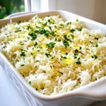 - 1 cup long-grain rice - 2 cups vegetable broth - 3 tablespoons olive oil - 4 cloves garlic, minced - 1 small onion, finely chopped - 1 teaspoon dried thyme - 1 teaspoon dried rosemary - Salt and pepper to taste - Fresh parsley, chopped (for garnish) - Additional herbs (basil, cilantro) - Lemon zest for freshness Garlic herb rice offers around 200 calories per serving. It provides a good mix of carbs and fats. Each serving has about 4 grams of protein and 8 grams of fat. The dish is light yet filling. This simple recipe keeps the focus on fresh flavors. The garlic and herbs blend well with the rice. It’s a great way to boost your meals. You can add other herbs or lemon zest for a twist. Enjoy! - Rinsing and draining the rice: First, grab 1 cup of long-grain rice. Rinse it under cold water. Keep rinsing until the water runs clear. This step removes excess starch. After rinsing, drain the rice well. - Chopping garlic and onion: Next, take 4 cloves of garlic. Mince them finely. Then, chop 1 small onion into small pieces. Having these ready makes cooking easier and faster. - Sautéing onions and garlic: In a medium saucepan, heat 3 tablespoons of olive oil over medium heat. Add the chopped onion first. Sauté the onion until it turns translucent, which takes about 3-4 minutes. Then, stir in the minced garlic. Cook for another 1-2 minutes. Be careful not to burn the garlic; it can turn bitter. - Toasting rice and combining ingredients: Now, add the rinsed rice to the saucepan. Stir it well to coat the rice with oil. Toast the rice for about 2 minutes. This adds a nice flavor. After toasting, pour in 2 cups of vegetable broth. Add 1 teaspoon of dried thyme, 1 teaspoon of dried rosemary, and salt and pepper to taste. Give it a quick stir to mix everything. - Cooking and simmering details: Bring the mixture to a boil. Once boiling, reduce the heat to low. Cover the saucepan and let it simmer for 15-18 minutes. This is when the rice absorbs all the liquid and becomes tender. - Fluffing the rice: After the cooking time, remove the saucepan from heat. Let it sit covered for an extra 5 minutes. This step helps the rice to finish cooking. Then, use a fork to fluff the rice gently. - Adding fresh parsley: Finally, stir in some freshly chopped parsley for a burst of color and flavor. Adjust the seasoning if you need to. Now, your garlic herb rice is ready to serve! Enjoy it with your favorite dishes. - Overcooking garlic: Garlic cooks fast. If you cook it too long, it turns bitter. Watch it closely and remove it once it’s fragrant. - Not rinsing rice properly: Rinsing rice is key. It removes excess starch and prevents it from being sticky. Rinse until the water runs clear. - Letting the rice sit after cooking: After you finish cooking, let the rice sit covered for about five minutes. This helps the grains firm up and improves texture. - Adjusting seasoning to personal taste: Taste your rice after cooking. You can always add more salt or herbs to boost the flavor. - Best proteins to serve with: Garlic herb rice pairs well with chicken, fish, or tofu. These proteins add great taste and texture. - Complementary vegetable sides: Serve it with grilled veggies like zucchini or bell peppers. Their flavors mix well with the rice and make a lovely plate. {{image_2}} You can make garlic herb rice even better with some simple tweaks. If you're looking for a vegan option, use vegetable broth instead of water. It adds depth and flavor. For those who like a kick, sprinkle in some red pepper flakes. This adds spice and excitement to each bite. Want to switch it up? You can use brown rice or quinoa instead of long-grain rice. Both options are healthy and add a nutty flavor. If you enjoy wild rice, give it a try. Wild rice offers a chewy texture and unique taste that makes your dish stand out. You can also give garlic herb rice a global twist. For a Mediterranean flavor, add herbs like oregano and dill. This change brings vibrant tastes to your plate. If you want something Asian-inspired, stir in some soy sauce or sesame oil. This will give the rice a rich, savory taste that pairs well with many dishes. To store leftover garlic herb rice, let it cool first. Place the rice in an airtight container. This keeps out moisture and odors. Make sure to seal it tightly. You can store it in the fridge for about 3 to 5 days. For the best results, use glass or plastic containers. These are sturdy and easy to clean. They also help keep the rice fresh. Avoid using metal containers, as they can react with the food. Freezing garlic herb rice is a great way to save it for later. First, let the rice cool completely. Then, scoop it into freezer bags. Press out as much air as possible before sealing. This helps prevent freezer burn. To thaw the rice, leave it in the fridge overnight. You can also use the microwave. Just add a splash of water and cover it. Heat in short bursts until hot. Stir often to warm it evenly. Garlic herb rice lasts about 3 to 5 days in the fridge. If you freeze it, the shelf life extends to about 2 to 3 months. Always check for signs of spoilage. If it looks or smells off, it’s best to toss it. Yes, you can use different rice types. Here are some great options: - Brown rice for a nutty flavor and more fiber. - Jasmine rice for a fragrant touch. - Basmati rice for a unique aroma and texture. - Quinoa for a protein boost and a gluten-free option. Each rice type has its own cooking time. Always check the package for instructions. You can prepare garlic herb rice in advance. Here are some tips: - Cook the rice as directed and let it cool. - Store it in an airtight container in the fridge. - It stays fresh for about 3-4 days. - To reheat, add a splash of broth or water for moisture. You can also freeze it. Just thaw it overnight in the fridge before reheating. You can add proteins or beans to make the dish heartier. Consider these ideas: - Cooked chicken or shrimp for a protein boost. - Black beans or chickpeas for a plant-based option. - Sautéed vegetables like bell peppers or zucchini for more flavor. - Nuts or seeds for crunch and healthy fats. These additions make the dish more satisfying and nutritious. This blog post shows you how to make garlic herb rice. You learned the ingredients, step-by-step instructions, and some variations. We also covered storage tips to keep your rice fresh and tasty. Experimenting with flavors and add-ins makes it fun and unique. Remember to adjust the recipe to fit your taste. You now have everything you need to create this dish for your meals or gatherings. Enjoy your cooking journey and savor each bite!