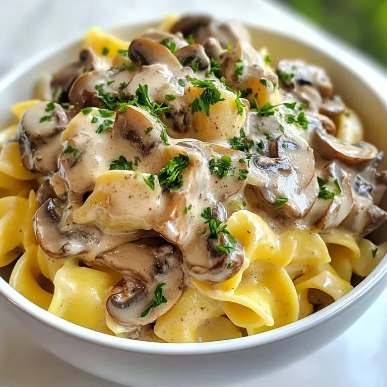 To make a delicious Creamy Mushroom Stroganoff, you will need the following ingredients: - 300g wide egg noodles (or pasta of choice) - 400g mixed mushrooms (button, cremini, or portobello), sliced - 1 medium onion, finely chopped - 2 cloves garlic, minced - 1 tablespoon olive oil - 1 tablespoon vegan butter or regular butter - 1 cup vegetable broth - 1 cup sour cream (or cashew cream for a vegan option) - 1 tablespoon soy sauce - 1 teaspoon Dijon mustard - 1 teaspoon paprika - Salt and pepper to taste - Fresh parsley, chopped (for garnish) These ingredients come together to create a rich and creamy dish that warms the soul. If you're looking for vegan options, use cashew cream instead of sour cream. This will keep the dish creamy without dairy. You can also swap the butter for vegan butter. If you want to change the pasta, any type works well, like penne or fettuccine. Choosing the right mushrooms makes a big difference. I recommend using a mix of button, cremini, and portobello mushrooms. Button mushrooms are mild and tender. Cremini mushrooms add depth with their earthy taste. Portobello mushrooms bring a hearty texture. Together, they create a flavorful base that enhances the dish's creaminess. {{ingredient_image_1}} To start, you need to cook the noodles. I choose wide egg noodles for a classic touch. Bring a large pot of water to a boil and add salt. Once boiling, add your noodles. Cook them according to the package instructions until they're al dente. This usually takes about 8-10 minutes. Drain the noodles and set them aside. Make sure to toss them with a little olive oil so they don’t stick! Next, we sauté the vegetables. Grab a large skillet and heat olive oil and vegan butter over medium heat. The oil makes it easier to cook the onions and butter adds a nice richness. Add the finely chopped onion and cook for 3-4 minutes until they soften. This builds a great base for your stroganoff. Now, add minced garlic and sliced mushrooms to the skillet. I like to use a mix of mushrooms like button, cremini, and portobello. Cook these for 5-7 minutes. They should become tender and release their moisture. This will deepen the flavor and make your dish more robust. Creating the sauce is the heart of this dish. Pour in the vegetable broth and soy sauce. Then add Dijon mustard and paprika for a kick of flavor. Let it simmer for about 5 minutes. This helps the liquid reduce slightly. Now, reduce the heat to low and stir in sour cream. You can use cashew cream for a vegan option. Combine everything well but avoid boiling. The sauce should be creamy and smooth. Adjust the taste with salt and pepper to your liking. Finally, add the cooked noodles to the creamy sauce. Toss them gently to coat well. Let everything heat together for another 2-3 minutes. Your creamy mushroom stroganoff is now ready to serve! To get a creamy texture, use sour cream or cashew cream. Cashew cream works great for a vegan option. Keep the heat low when mixing in the cream. This helps avoid curdling. Stir gently to combine well with the sauce. You can also add a bit of pasta water for extra creaminess. This water has starch, which makes the sauce silkier. One mistake is boiling the sauce after adding the cream. Boiling can cause the cream to separate. Another common error is not cooking the mushrooms enough. Undercooked mushrooms can taste rubbery. Make sure the mushrooms release their moisture and get tender. Lastly, don’t skip the seasoning. Salt and pepper enhance the dish’s flavor. Taste as you cook to find the right balance. Start with a good base by sautéing onions and garlic. This builds flavor. Add soy sauce to deepen the taste. A dash of Dijon mustard adds richness. Don’t forget paprika for a subtle smokiness. Always taste your sauce before mixing in the noodles. Adjust salt and pepper as needed. Fresh parsley brings a fresh note and adds color. Pro Tips Use Fresh Mushrooms: Fresh mushrooms enhance the flavor and texture of the dish. Avoid canned mushrooms for the best results. Perfectly Cooked Noodles: Make sure to cook your noodles al dente so they retain their shape and texture when mixed with the sauce. Add a Splash of Wine: For an extra depth of flavor, consider adding a splash of white wine when sautéing the mushrooms. Experiment with Herbs: Fresh herbs like thyme or dill can elevate the dish. Add them at the end for a bright, fresh flavor. {{image_2}} You can easily make a vegan version of this dish. Instead of sour cream, use cashew cream. This gives a rich, creamy taste. Simply soak cashews in water for a few hours. Drain and blend them with a bit of water until smooth. This will mimic the texture of sour cream perfectly. If you need gluten-free noodles, there are great options. Use rice noodles, quinoa pasta, or even zucchini noodles. Just cook them according to the package instructions. These alternatives work well with the creamy mushroom sauce. Want to add protein? You can include cooked chicken, beef, or turkey. Simply sauté the meat with the onions. If you prefer plant-based options, try adding chickpeas or lentils. They blend well with the sauce and add a nice texture. Both choices make the dish more filling and satisfying. To store leftover stroganoff, let it cool first. Use an airtight container. Place it in the fridge. It will last for about 3 to 4 days. I like to label the container with the date. This helps me keep track of freshness. When reheating, use a skillet on low heat. Add a splash of vegetable broth or water. This helps keep the sauce creamy. Stir often to avoid sticking. You can also microwave it in short bursts. Cover it with a microwave-safe lid. This will help keep the moisture in. You can freeze stroganoff for later use. Place it in a freezer-safe container. Leave some space for expansion. It will freeze well for about 2 to 3 months. To thaw, move it to the fridge overnight. Reheat it gently, adding a little broth if needed. This keeps the dish smooth and tasty. Yes, you can make Creamy Mushroom Stroganoff ahead of time. Simply follow the recipe and let it cool. Store it in an airtight container in the fridge. When you're ready to eat, reheat it on the stove over low heat. Add a splash of vegetable broth or water to keep it creamy. If you want a substitute for sour cream, try using cashew cream or plain yogurt. Both options work well and keep the dish creamy. You can also use a mix of silken tofu and lemon juice for a vegan option. Blend until smooth for the best results. To thicken your Stroganoff, you can add a bit of cornstarch. Mix one tablespoon of cornstarch with two tablespoons of cold water. Stir this mixture into your Stroganoff while it simmers. Let it cook for a few minutes until it thickens. You can also reduce the broth by simmering longer. Yes, dried mushrooms can be used in this recipe. Just soak them in warm water for about 20 minutes to rehydrate. Use the soaking liquid as part of your broth for extra flavor. Remember to chop the rehydrated mushrooms before adding them to your dish. The best side dish for Stroganoff is a simple green salad. It adds freshness and crunch. You can also serve crusty bread to soak up the creamy sauce. Roasted vegetables or steamed broccoli are great options too. They balance the meal nicely. In this article, we explored how to make a great creamy mushroom stroganoff. We covered the main ingredients, cooking steps, and tips for the best flavor and texture. I shared ideas for vegan options, alternative noodles, and how to store leftovers. Remember, making stroganoff is fun and can be adjusted to your tastes. You can enjoy it fresh or save it for later. Try different mushrooms and ingredients to find your favorite version. Happy cooking!
