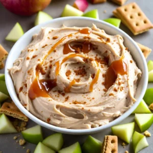 To make this tasty dip, you need a few key items: - 8 oz cream cheese, softened - 1/2 cup powdered sugar - 1 tsp vanilla extract - 1/2 cup sour cream - 1 cup caramel sauce, divided - 1 medium apple, finely diced (Granny Smith or Honeycrisp work best) - 1/2 tsp cinnamon These ingredients come together to create a rich and creamy base. The cream cheese gives the dip its smooth texture. The powdered sugar adds sweetness, while the vanilla extract enhances the flavor. Sour cream adds a nice tang, balancing the sweetness. You can add a few more ingredients for added crunch and taste: - 1/4 cup chopped walnuts or pecans These nuts provide a delightful crunch. They also add a nutty flavor that complements the apple and caramel. If you prefer a nut-free option, feel free to skip this ingredient. To enjoy your dip, you will need some tasty dippers: - Sliced apples - Graham crackers Sliced apples are perfect for dipping. They bring a fresh taste and nice crunch. Graham crackers add a sweet touch and are very popular. You can even mix and match your dippers for fun and variety. {{ingredient_image_1}} Start by getting a large mixing bowl. Place 8 oz of softened cream cheese inside. Use a hand mixer to beat it until it is smooth and creamy. This step is key for a great dip base. Next, slowly add in 1/2 cup of powdered sugar. Keep mixing until everything is well blended. Then, pour in 1 tsp of vanilla extract and 1/2 cup of sour cream. Mix again until the dip looks silky and smooth. Now, stir in 1/2 cup of caramel sauce, but save some for later. Add in a medium apple, finely diced, and 1/2 tsp of cinnamon. Gently fold these in until they are mixed well. If you want a crunch, fold in 1/4 cup of chopped walnuts or pecans. Transfer your dip to a serving bowl. Drizzle the remaining caramel sauce on top. This makes it look tasty and inviting. Serve with sliced apples and graham crackers for dipping. Enjoy this simple and delicious treat! To make the creamiest dip, start with softened cream cheese. This helps it blend well. Use a hand mixer to beat the cream cheese until it is smooth. Gradually add the powdered sugar and mix until combined. Then, pour in the sour cream and vanilla extract. Mix again until the dip is silky and smooth. This method ensures a perfect texture. For a beautiful display, use a shallow bowl. Transfer the dip into the bowl. Drizzle the remaining caramel sauce on top. This adds a nice touch. Arrange sliced apples and graham crackers around the bowl for easy dipping. To make it pop, sprinkle a little cinnamon on top. This will catch the eye of your guests. You can switch out ingredients for different flavors. If you want a nutty taste, try adding chopped pecans or walnuts. For a sweeter touch, use flavored caramel sauces like sea salt or chocolate. If you prefer a fruity note, mix in diced pears or berries. These changes can make your dip unique and exciting. Pro Tips Choose the Right Apple: For the best flavor balance, opt for tart apples like Granny Smith or sweet ones like Honeycrisp. They add a nice contrast to the creamy dip. Chill Before Serving: Let the dip chill in the fridge for at least 30 minutes before serving. This allows the flavors to meld together beautifully. Make it Nut-Free: If you're serving guests with nut allergies, simply omit the walnuts or pecans. The dip will still be delicious! Presentation Matters: For an attractive display, use a shallow bowl and drizzle extra caramel sauce on top. Garnish with a sprinkle of cinnamon for added visual appeal. {{image_2}} If you want to skip the nuts, that&rsquo;s easy! Use seeds instead. Sunflower seeds or pumpkin seeds add crunch without the nut flavor. If you prefer a nutty taste, try almonds or cashews. These nuts blend well with the dip's creaminess. You can change up the caramel sauce for fun flavors. Try salted caramel for a sweet and salty mix. For a spicy kick, use a cinnamon caramel sauce. Chocolate caramel sauce can make this dip extra rich and sweet. Each twist adds a unique taste to your dip. This dip is perfect for fall. You can add pumpkin puree for a festive touch. A pinch of nutmeg can give it a warm flavor. Dried cranberries or raisins can add a pop of color and sweetness. These changes make the dip special for autumn gatherings. To store leftover cheesecake dip, place it in an airtight container. Make sure to seal it tightly. Keep it in the fridge. This way, the dip stays fresh and tasty for later. When you want to enjoy it again, take it out of the fridge. Let it sit at room temperature for about 30 minutes. This helps it soften. If you want to warm it up, you can heat it in the microwave. Use short bursts of 10-15 seconds. Stir between each burst to avoid overheating. The cream cheese dip can last about 3-5 days in the fridge. The apples may brown slightly, but they should stay okay. If you see any changes in smell or texture, it&rsquo;s best to toss it. Always check the date on your ingredients too. This helps keep your dip safe and delicious. Yes, you can make this dip ahead of time. Prepare it a few hours earlier. Just cover it tightly and place it in the fridge. This dip gets better as the flavors mix. You can serve this dip with sliced apples and graham crackers. Other great options are pretzels and vanilla wafers. These pair well with the sweet and creamy taste. This dip lasts about 3-5 days in the fridge. Store it in an airtight container. If it separates, just stir it gently before serving again. Yes, you can use low-fat cream cheese. The dip will still taste great. It may be a bit less rich but still creamy and delicious. Yes, you can make a vegan version. Use coconut cream instead of cream cheese. For sweetness, use maple syrup or agave nectar. This keeps the creamy texture and flavor. Caramel Apple Cheesecake Dip is a fun and tasty treat. We covered the essential and optional ingredients for rich flavor. You learned step-by-step instructions for a smooth mix and final touches for serving. We shared tips for the creamiest dip and how to present it beautifully. Variations can fit any occasion, and knowing how to store it helps reduce waste. Remember, this dip is easy to make and enjoy. You can create it your way!