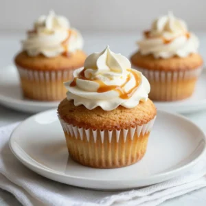 To make these delightful caramel macchiato cupcakes, gather the following ingredients: - 1 &frac12; cups all-purpose flour - 1 cup granulated sugar - &frac12; cup unsalted butter, softened - 2 large eggs - 1 cup brewed coffee, cooled - &frac14; cup milk - 1 teaspoon vanilla extract - 1 tablespoon baking powder - &frac12; teaspoon salt - &frac12; cup caramel sauce (plus extra for drizzling) - 1 cup heavy whipped cream - 2 tablespoons powdered sugar - 1 teaspoon espresso powder Using high-quality ingredients makes a big difference. Here are some brands I trust: - Flour: King Arthur Flour for its consistency and quality. - Sugar: Domino Sugar for its pure flavor. - Butter: Kerrygold for a rich, creamy taste. - Coffee: Peet&rsquo;s Coffee for a bold flavor that shines through. - Caramel Sauce: Ghirardelli for a smooth, sweet finish. - Whipping Cream: Organic Valley for a fresh, luscious cream. You can easily adjust the recipe for different diets: - Dairy-Free: Use coconut milk and vegan butter instead. - Gluten-Free: Swap all-purpose flour with a gluten-free blend. - Sugar-Free: Substitute sugar with a sugar alternative like erythritol. Feel free to mix and match these options to suit your taste! {{ingredient_image_1}} 1. Preheat your oven to 350&deg;F (175&deg;C). This step is key for even baking. 2. Line a 12-cup muffin pan with cupcake liners. This helps with easy removal. 3. In a large mixing bowl, cream the softened butter and granulated sugar. Beat until light and fluffy. This adds air for a nice texture. 4. Add the eggs one at a time. Mix well after each addition. Then, mix in the vanilla extract for added flavor. 5. In a separate bowl, combine the flour, baking powder, espresso powder, and salt. This helps with even mixing later. 6. Gradually add the dry ingredients to the creamed mixture. Alternate with the brewed coffee and milk. Mix until just combined. This keeps the cupcakes light. 7. Gently fold in the caramel sauce. Make sure it spreads evenly throughout the batter. 1. Divide the batter evenly among the cupcake liners. Fill each about 2/3 full. This gives them room to rise. 2. Bake in the preheated oven for 18-20 minutes. Check for doneness by inserting a toothpick into the center. It should come out clean. 3. If the toothpick has batter on it, bake for a few more minutes. Avoid opening the oven too soon. This can cause the cupcakes to sink. 4. Let the cupcakes cool in the pan for 5 minutes. Then, transfer them to a wire rack to cool completely. This step is important for the frosting later. 1. In a medium bowl, whip the heavy cream with powdered sugar. Beat until soft peaks form. This makes a great topping. 2. Once the cupcakes are cool, top each with a generous dollop of whipped cream. This adds a nice touch. 3. Drizzle additional caramel sauce on top of the whipped cream. This makes each bite extra special. Enjoy your delicious treats! To make the best caramel macchiato cupcakes, follow these steps: - Use fresh coffee: Brew your coffee just before using it. Fresh coffee gives the best flavor. - Room temperature ingredients: Let your butter and eggs sit out before baking. This helps create a smooth batter. - Measure flour correctly: Spoon flour into your measuring cup and level it off with a knife. Too much flour can make cupcakes dense. - Don't overmix: Mix until just combined. Overmixing can lead to tough cupcakes. Once your cupcakes are cool, it&rsquo;s time to get creative: - Whipped cream topping: Use a piping bag for a beautiful swirl of whipped cream. - Caramel drizzle: Drizzle extra caramel sauce over the whipped cream for a sweet touch. - Garnish: Top with coffee beans or a sprinkle of cocoa powder. This adds a nice visual and flavor element. - Presentation: Serve on a pretty platter to impress your guests. Here are some pitfalls to watch for: - Not preheating the oven: Always preheat your oven. This ensures your cupcakes bake evenly. - Filling liners too full: Fill each liner only 2/3 full. They need room to rise. - Skipping the cooling step: Letting cupcakes cool completely before frosting is key. Frosting on warm cupcakes can melt and slide off. - Using expired baking powder: Always check your baking powder for freshness. Old baking powder can lead to flat cupcakes. Pro Tips Use Freshly Brewed Coffee: For the best flavor, always use freshly brewed coffee that has cooled. This enhances the coffee taste in your cupcakes. Check Oven Temperature: Ensure your oven is calibrated correctly. An oven thermometer can help you achieve the perfect baking temperature for even results. Whip the Cream Properly: Be careful not to over-whip the heavy cream, as it can turn into butter. Stop whipping once soft peaks form for a light and fluffy topping. Caramel Sauce Alternatives: If you&rsquo;re short on time, store-bought caramel sauce works perfectly, but homemade caramel can elevate the flavor of your cupcakes. {{image_2}} You can make these cupcakes even more fun. Here are some ideas: - Chocolate: Add chocolate chips for a rich twist. - Nuts: Walnuts or pecans give a crunchy texture. - Spices: A pinch of cinnamon or nutmeg adds warmth. Mix and match to find your favorite flavor! Want a vegan or paleo version? Here&rsquo;s how: - Vegan: Use flax eggs instead of regular eggs. Replace butter with coconut oil. - Paleo: Swap all-purpose flour with almond or coconut flour. Use honey instead of sugar. These changes still keep the cupcakes tasty and satisfying. Cupcakes can come in many sizes. Here are some ideas: - Mini Cupcakes: Perfect for bite-sized treats. Adjust baking time to 12-15 minutes. - Larger Formats: Bake in a cake pan. Check for doneness around 25-30 minutes. Serving is key! Use a pretty platter and add coffee beans for a nice touch. Enjoy! To keep your caramel macchiato cupcakes fresh, store them in an airtight container. This helps lock in moisture and flavor. You can leave them at room temperature for up to two days. If you want to keep them longer, place them in the fridge. Just be sure to let them come back to room temperature before serving. This keeps the taste and texture at their best. Freezing cupcakes is simple. First, let your cupcakes cool completely. Wrap each cupcake tightly in plastic wrap. Then, place them in a freezer-safe bag or container. This will help avoid freezer burn. You can freeze them for up to three months. To thaw, take them out and leave them in the fridge overnight. When you&rsquo;re ready to enjoy, add your whipped cream and caramel drizzle. Caramel macchiato cupcakes can last up to four days at room temperature. If stored in the fridge, they can stay fresh for about a week. To tell if they are no longer good, check for any off smells or mold. If they look or smell strange, it&rsquo;s best to throw them away. Keeping an eye on freshness ensures you enjoy the best flavors in every bite. To boost the coffee taste in your cupcakes, use strong brewed coffee. You can also add espresso powder to the batter. Mix in about one teaspoon for a nice kick. Another option is to replace some milk with coffee. This adds depth without changing the texture. - Use strong brewed coffee. - Add 1 teaspoon of espresso powder. - Replace some milk with coffee. Yes, you can use instant coffee as a substitute for brewed coffee. To do this, mix 2 tablespoons of instant coffee with 1 cup of hot water. This will give you a strong coffee flavor. Just make sure it cools before adding it to your batter. - Mix 2 tablespoons instant coffee with 1 cup hot water. - Let it cool before using. If your cupcakes sink in the middle, it could be due to overmixing the batter. Make sure you mix just until combined. Another reason is underbaking. Always check with a toothpick. If it comes out wet, they need more time. Lastly, make sure your oven is at the right temperature. - Avoid overmixing the batter. - Check doneness with a toothpick. - Preheat your oven to the right temperature. You&rsquo;ve learned about the key ingredients and how to make delicious cupcakes. We covered preparation, baking, and frosting in detail. With helpful tips, you can avoid common mistakes and decorate beautifully. Explore flavor and dietary variations to suit your taste. You also know how to store and freeze your treats for later. Trust these steps and tips to create delightful cupcakes every time. Now, you&rsquo;re ready to impress everyone with your baking skills! Enjoy your cupcake journey.