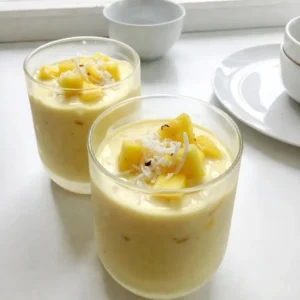 - 1 cup fresh pineapple chunks - 1 ripe banana Fresh pineapple gives your smoothie a bright taste. It adds sweetness and a tropical vibe. The banana makes it creamy and smooth. Both fruits blend well together. - 1 cup coconut milk (or any non-dairy milk) - &frac12; cup Greek yogurt (or dairy-free yogurt) Coconut milk adds a rich, smooth flavor. It pairs perfectly with the fruits. Greek yogurt adds protein and creaminess. You can switch to dairy-free yogurt for a vegan option. - 2 tablespoons shredded coconut (unsweetened) - 1 tablespoon honey or maple syrup (optional) - Ice cubes (about 1 cup, adjust for desired thickness) Shredded coconut gives a nice texture and flavor. Honey or maple syrup can sweeten your smoothie if you like it sweeter. Ice cubes chill the drink and make it refreshing. Adjust the amount for your preferred thickness. {{ingredient_image_1}} - First, wash the fresh pineapple and banana. - Cut the pineapple into chunks. - Slice the banana into smaller pieces. - In your blender, combine the pineapple chunks, banana slices, and coconut milk. - Next, add the Greek yogurt for creaminess. - If you want a sweeter taste, add honey or maple syrup now. - Toss in the shredded coconut and ice cubes. - Blend everything on high until smooth. - If your smoothie is too thick, add a bit more coconut milk. - Taste your smoothie and adjust sweetness if needed. To get the right texture, use coconut milk. If you want it thicker, add less. For a chill factor, frozen fruits work great. They keep your smoothie cold without watering it down. You can freeze fresh pineapple or bananas ahead of time. This way, you always have them ready for your smoothie. Serving your smoothie in chilled glasses makes it look fancy. You can use mason jars too! Sprinkle extra shredded coconut on top for a nice touch. Garnishing with a slice of pineapple adds color and fun. You can even add a tiny umbrella for a tropical vibe. This makes your drink feel like a vacation in a glass. If you have dairy allergies, try dairy-free yogurt. Almond or soy yogurt works really well. For sweeteners, honey is great, but maple syrup is a good choice too. If you're avoiding sugar, try using agave syrup or stevia. These options make sure everyone can enjoy this smoothie! Pro Tips Use Frozen Pineapple: For a thicker and colder smoothie, consider using frozen pineapple chunks instead of fresh ones. Experiment with Flavors: Add a handful of spinach or kale for extra nutrients without altering the tropical flavor. Adjust Sweetness: Taste your smoothie before serving and adjust the sweetness to your preference, especially if using fresh, less ripe fruits. Chill Your Ingredients: For the best refreshing experience, chill your coconut milk and yogurt in advance. {{image_2}} You can easily change the flavors of your smoothie. Adding mango gives a sweet twist. Berries, like strawberries or blueberries, add color and taste. You can also blend in tropical greens, like spinach or kale. This adds nutrition without changing the flavor much. These greens make your smoothie even healthier while keeping it delicious. The liquid you choose makes a big difference. Almond milk or oat milk can replace coconut milk for a different taste. If you want extra hydration, use coconut water. This keeps the tropical vibe while adding a refreshing kick. Each liquid gives a unique texture and flavor. Want to make your smoothie more filling? Add protein powder. This gives you a protein boost without changing the taste. You can also use nut butter, like almond or peanut butter. This adds richness and makes the smoothie creamier. Both options are great for a tasty and healthy drink. To store leftover smoothie, pour it into a clean jar. Seal it tightly. Place it in the fridge. It stays fresh for about 24 hours. Shake or stir it before drinking. If it separates, that's normal. You can freeze the smoothie for later use. Pour it into ice cube trays or freezer bags. This way, you can enjoy it later. To thaw, place it in the fridge overnight. For quicker results, sit it in a bowl of cold water. Blend it again if needed for a smooth texture. If you have overriped bananas, use them in smoothies. They add natural sweetness and creaminess. Peel and slice them before adding to your blender. You can freeze them too. This way, you always have ripe bananas ready for your next smoothie. Yes, you can make this smoothie ahead of time. To prep, blend all the ingredients. Pour the smoothie into a jar. Seal it tight and store it in the fridge. It stays fresh for up to 24 hours. When ready to drink, give it a good shake. If it&rsquo;s too thick, add a splash of coconut milk. Absolutely! To make this smoothie vegan, swap Greek yogurt for dairy-free yogurt. Use maple syrup instead of honey for sweetness. Coconut milk is already dairy-free. This way, you enjoy all the creamy goodness without any animal products. To thicken your smoothie, add more banana or some frozen pineapple. You can also use less coconut milk. Adding a bit of Greek yogurt will help as well. Just blend until smooth. If it&rsquo;s too thick, you can always add a little more coconut milk to adjust. To wrap up, making a delicious smoothie is simple and fun. Use fresh pineapple, ripe bananas, coconut milk, and Greek yogurt for creaminess. Blend well, add sweeteners, and finish with shredded coconut and ice. Remember, you can switch fruits, try different liquids, and add proteins for more flavor and nutrition. Store any leftovers in the fridge or freeze for a treat later. Enjoy your smoothies, and don't hesitate to experiment with variations!